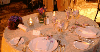 sweetheart table of specialty linens, custom painted wine goblets and champagne flutes