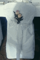 white chair cover with roses in sash